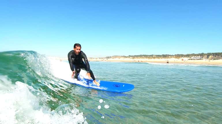 Surfing the waves of the Atlantic Ocean in Lisbon, Portugal