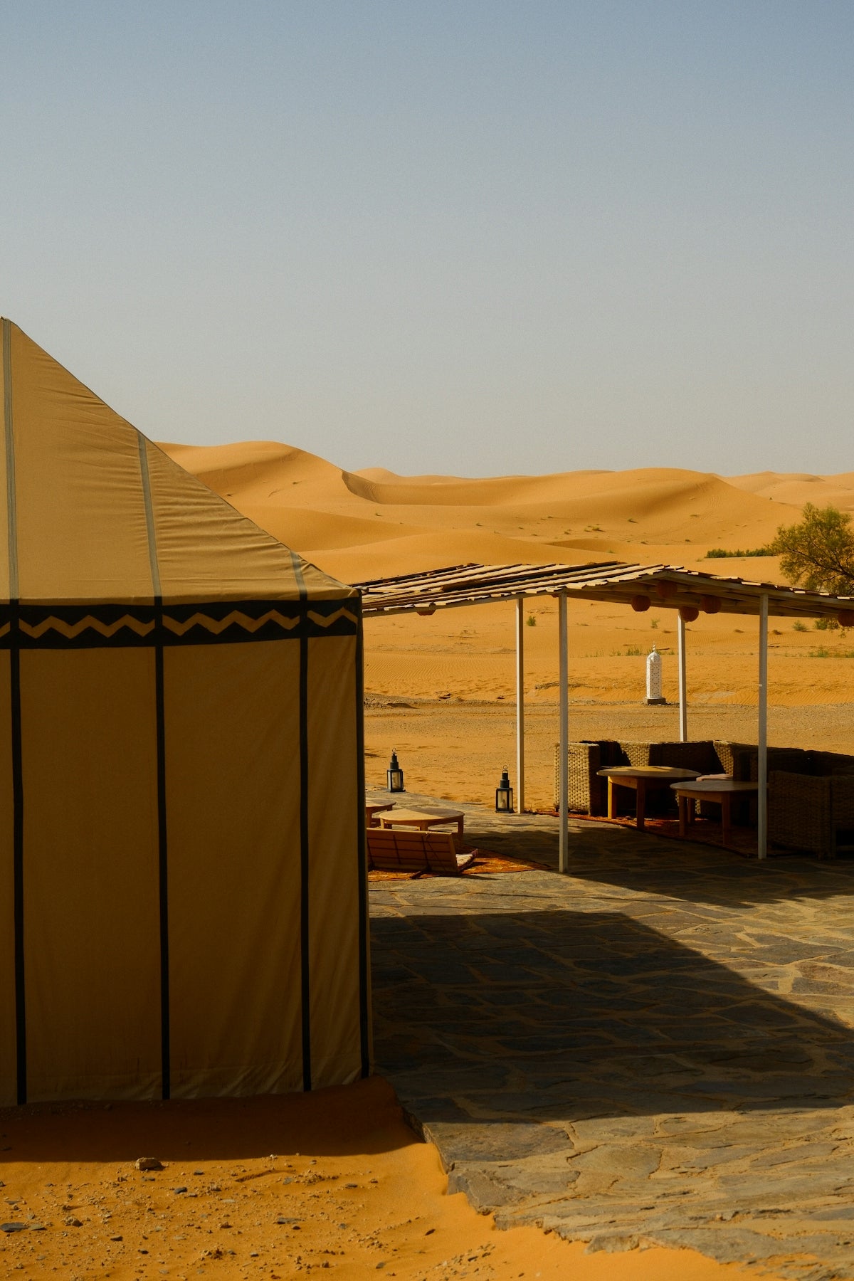 Desert camp with tents and seating area