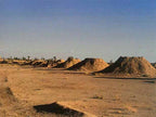 Desert landscape with multiple large sand mounds under clear blue sky highlighting the 2-Day Tour from Boumalne Dades experience