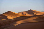Sandy dunes of Erg Chebbi under clear sky with soft shadows highlighting desert curves on 2-Day Tour from Boumalne Dades
