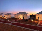 Desert camping tents with illuminated lanterns and red carpet pathways at dusk, perfect for a 3 Days Tour experience