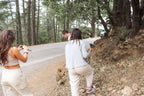 Group of tourists taking photos of monkeys in a dry forest area on a 4-day desert tour with casual light clothing