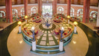 Agadir Beach Club Hotel lobby with circular seating arrangement, terracotta columns, patterned rugs, and large arched windows