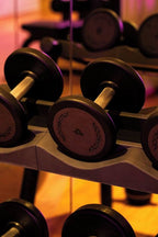 Barcelo Anfa Casablanca gym dumbbells with black weights and metallic handles on a rack