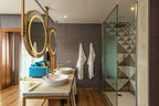 Barcelo Anfa Casablanca hotel bathroom with wood finishes, double vessel sinks, round mirrors and glass shower
