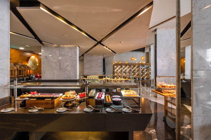 Barcelo Anfa Casablanca hotel buffet with pastries, fruit and plated dishes in a modern marble dining area