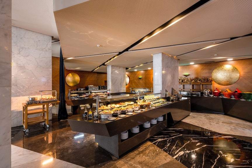 Barcelo Anfa Casablanca hotel buffet restaurant with a modern marble interior and extensive food display