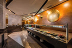 Barcelo Anfa Casablanca hotel buffet restaurant with modern wood walls, marble floors, and plated dishes