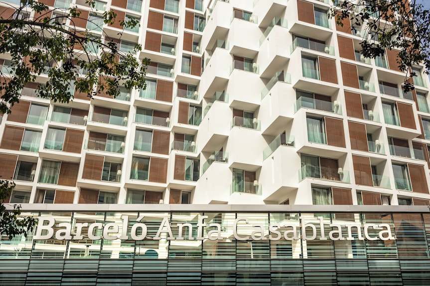 Barcelo Anfa Casablanca hotel exterior with white facade, brown panels, glass balconies, and prominent signage