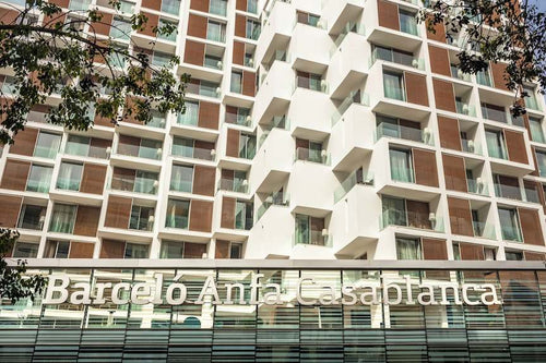 Barcelo Anfa Casablanca hotel exterior with white facade, brown panels, glass balconies, and prominent signage