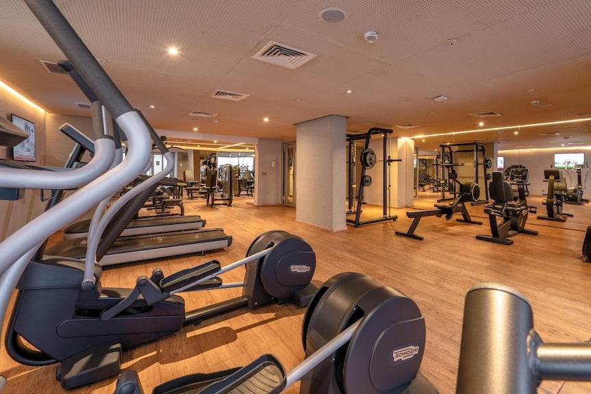 Barcelo Anfa Casablanca hotel gym with modern cardio machines, rowing equipment, weight racks, and warm wood flooring