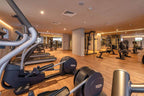 Barcelo Anfa Casablanca hotel gym with modern cardio machines, rowing equipment, weight racks, and warm wood flooring