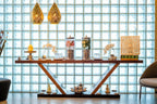 Barcelo Anfa Casablanca hotel lobby with glass block wall, wooden console, ornate gold lanterns and floral décor