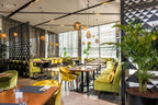 Barcelo Anfa Casablanca hotel restaurant with green velvet seating, geometric patterned screens, and pendant lights