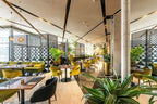 Barcelo Anfa Casablanca hotel restaurant with modern marble interior, green velvet chairs, plants and geometric screens