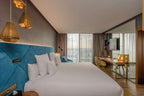 Barcelo Anfa Casablanca hotel room with white bed, blue upholstered headboard, and modern furnishings