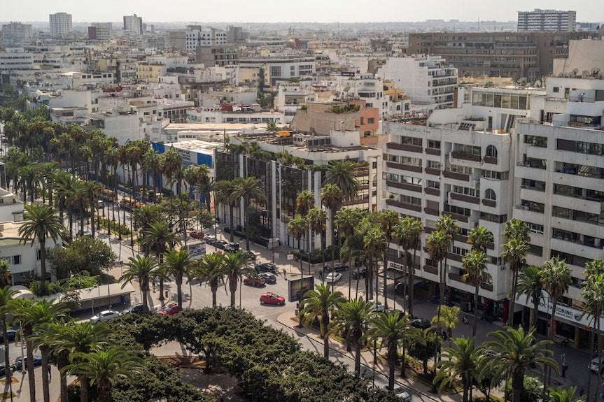 Barcelo Anfa Casablanca cityscape with palm-lined streets, dense urban buildings, and landscaped central park