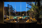 Barcelo Anfa Casablanca restaurant dining table with black linens, gold napkins, glassware, and pool view