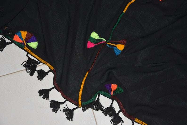 Berber Scarf Embroidery on black cotton and wool fabric with multicolored geometric stitched patterns and black tassels along the edges