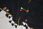 Berber Scarf Embroidery on black cotton and wool fabric with multicolored geometric stitched patterns and black tassels along the edges