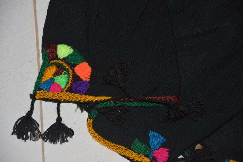 Berber Scarf Embroidery in black cotton and wool with colorful geometric patterns and tassels along the edges.