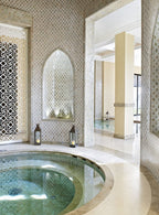 Indoor circular spa pool with mosaic-tiled walls and decorative arches showcasing Four Seasons Resort Marrakech luxury design