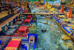 From Marrakech to Ourika Valley tour with colourful Moroccan riverside cushions, rugs, umbrellas and flowing stream