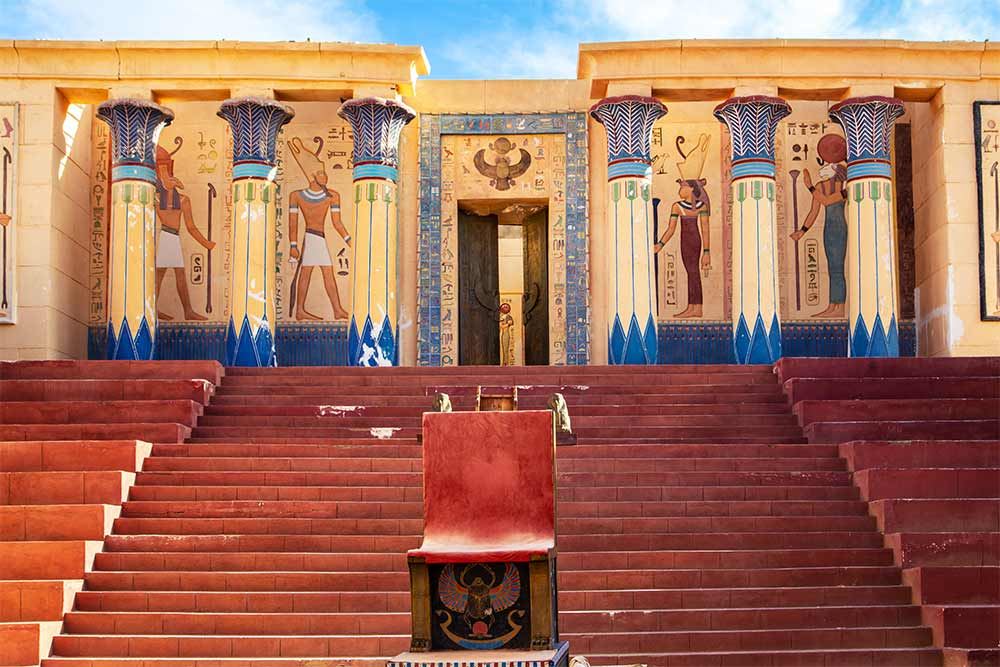From Marrakech: To Sahara Tour featuring colourful Egyptian-style murals, painted columns, and red stone steps