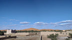 Hassilabiad Appart Hotel beige desert buildings with flat roofs surrounded by trees under blue sky