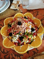 Hotel auberge Sahara colorful fresh vegetable salad with corn, tomatoes, onions, black olives, and tuna, garnished with orange slices