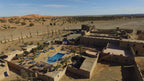 Hotel Kasbah Ksar Bicha with traditional kasbah architecture and courtyard swimming pool set in arid desert landscape