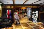 Hotel Xaluca Dades gift shop interior with colorful scarves, postcards, traditional Moroccan crafts, and decorative textiles