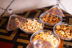 Kal Tenere Agafay glass bowls with assorted nuts including cashews, almonds, walnuts, and chickpeas on patterned surface