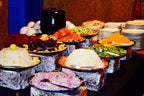 Kasbah Hotel Bar buffet display with colorful platters of rice, salads, fruits, and vegetables in Moroccan-style bowls