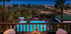 La Mamounia Marrakech view of illuminated outdoor pool area with surrounding palm trees and city lights at dusk
