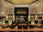 La Mamounia Marrakech elegant hotel lobby with beige and brown sofas, ornate pillars, intricate ceiling design, and ambient lighting