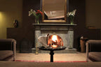 Le Berbere Palace Ouarzazate cozy lounge area with gray marble fireplace, two brown armchairs, and a table with champagne