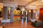 Le Berbere Palace Ouarzazate hotel lobby with mosaic tile columns, terracotta floor, water fountain, and seating area
