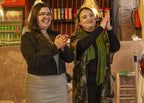 Marrakech Agafay Desert dinner show with two women clapping during live entertainment