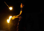 Marrakech Agafay Desert fire performer spinning flaming torches during a live evening show