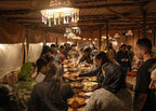 Marrakech Agafay Desert traditional Moroccan dinner served to diners inside a rustic Berber-style tent