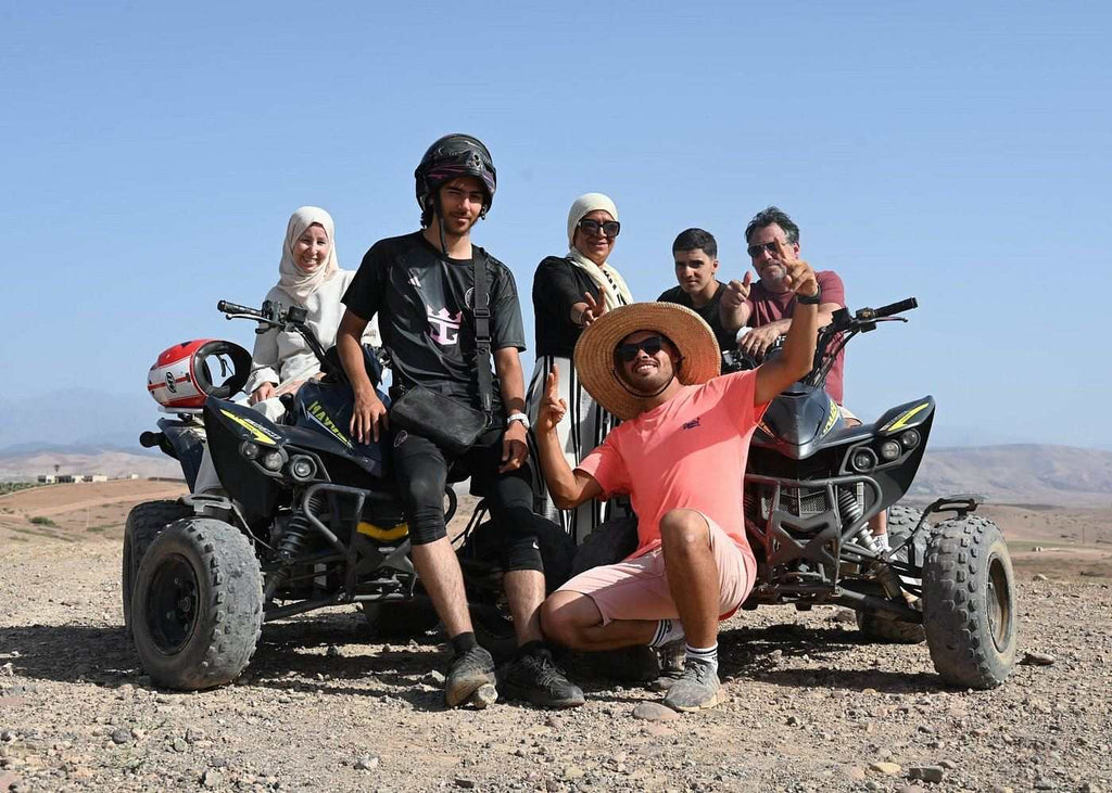 Marrakech Agafay Desert quad biking tour with five riders posing beside two black all-terrain quad bikes