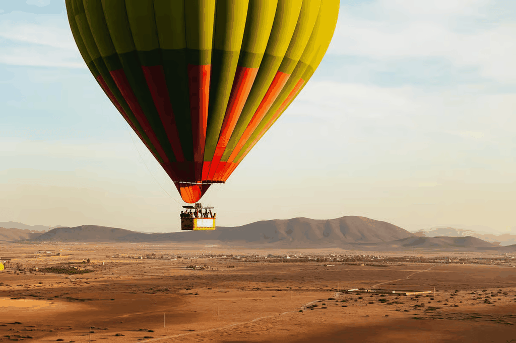 Marrakech by air hot air balloon with striped yellow, green and red envelope and passenger basket