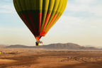 Marrakech by air hot air balloon with striped yellow, green and red envelope and passenger basket
