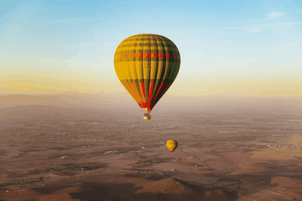 Marrakech by air hot air balloon ride with yellow and black striped balloons and red accents