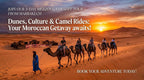 Merzouga desert tour featuring a group of people riding camels led by a guide in blue on golden sand dunes during a vibrant sunset in Morocco