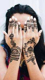 Moroccan Henna Tattoo featuring intricate black geometric and floral patterns on both hands and wrists of a person.