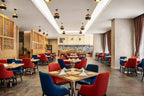 Novotel Makkah Thakher City restaurant with modern dining area, red and blue upholstered chairs, and set tables
