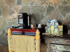 Riad Chay Boutique wooden table with coffee machine, glass cups, water bottles, and woven chair against stone wall