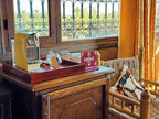 Riad Chay Boutique cozy corner with wooden table, yellow espresso machine, glass jars, and woven chair with colorful cushion